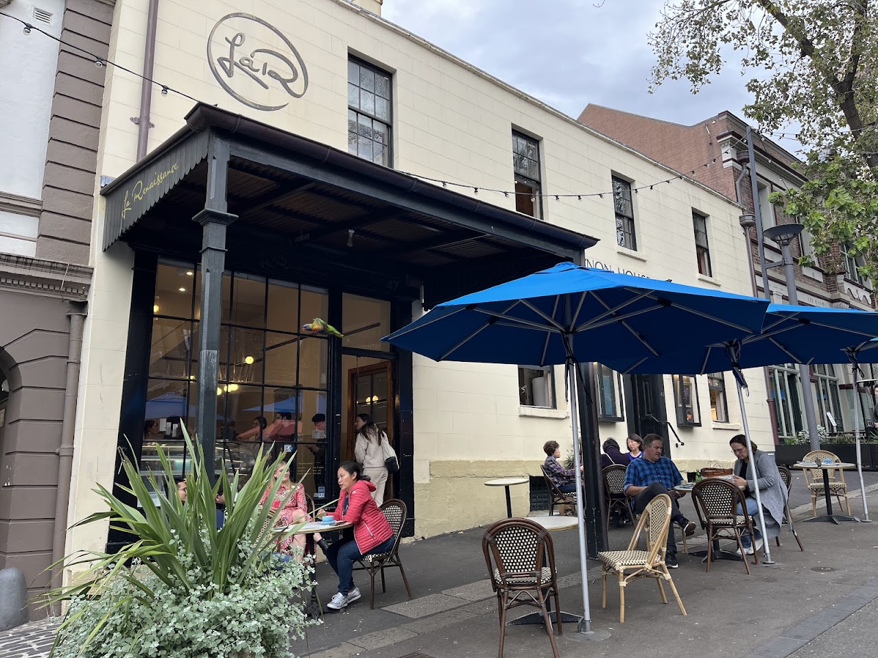La Renaissance storefront with outdoor tables